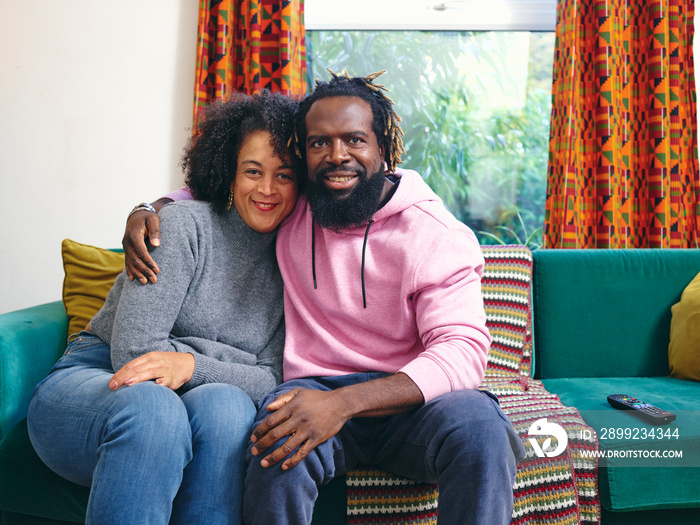 Portrait of couple sitting on sofa