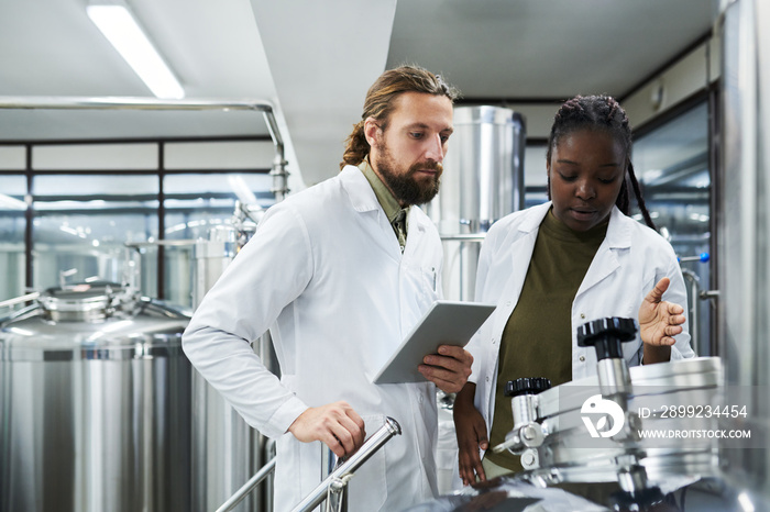 Brewery technologists controlling process of beer fermentation