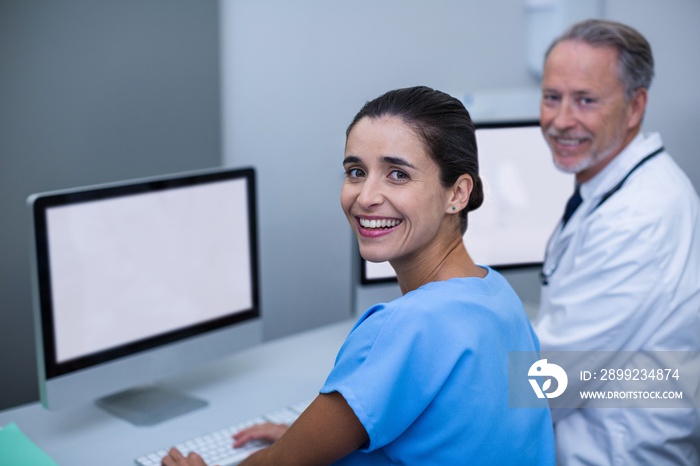 Doctor and nurse working on computer