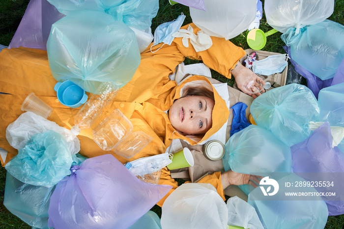 Woman suffering of hoarding abnormal disorder at her planet and laying around the rubbish