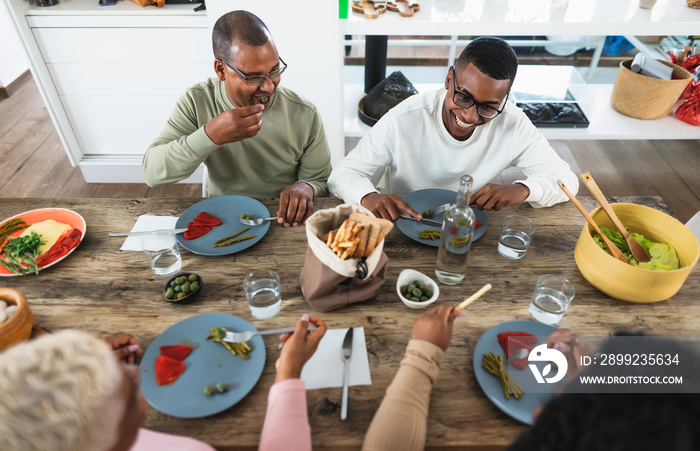 Happy black family eating healthy lunch together at home