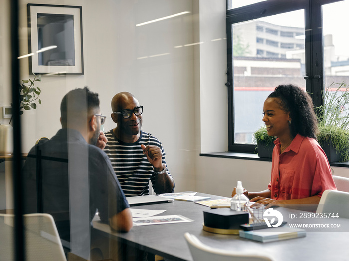 Colleagues talking at business meeting