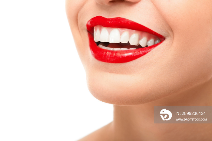 Beautiful young woman with healthy teeth on white background