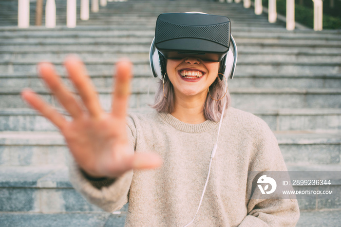 Young caucasian woman wearing vr goggles outdoor