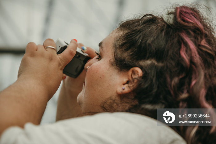 plus size woman takes picture with camera