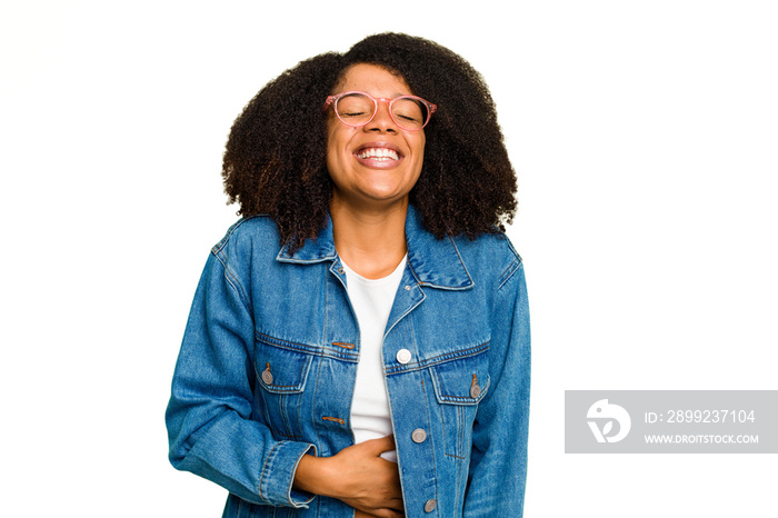 Young African American woman isolated touches tummy, smiles gently, eating and satisfaction concept.