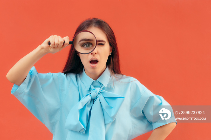 Funny Curious Girl Holding a Magnifying Glass