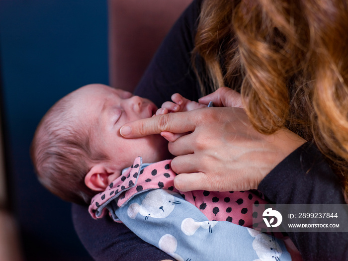 Close-up of woman holding baby son   at home