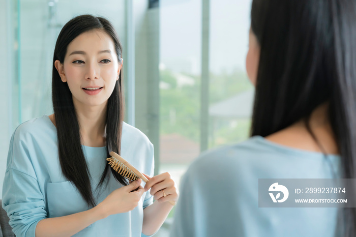 beautiful asian woman makeup and hair set wirh mirror in bathroom with morning light