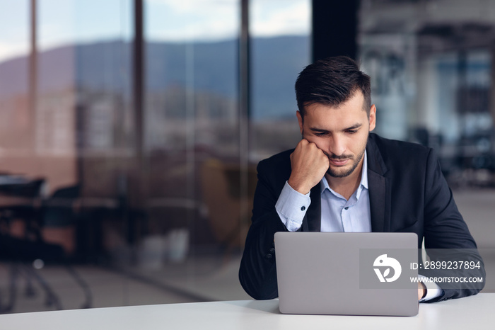 Portrait of worried young man at workplace. Stress concept