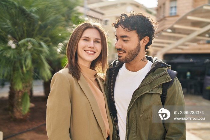 Man and woman smiling confident hugging each other at street