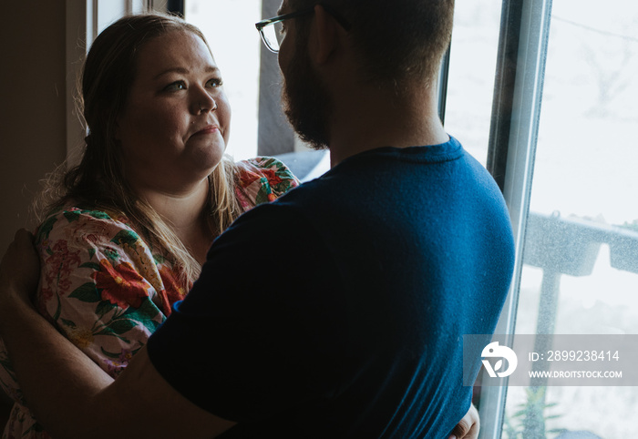 plus size woman smiles at husband