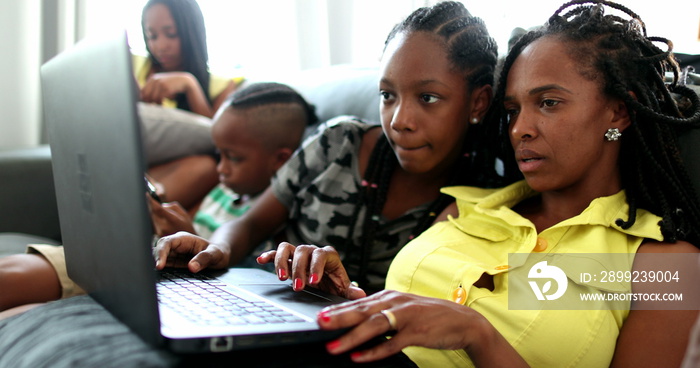 Happy black African american family using laptop