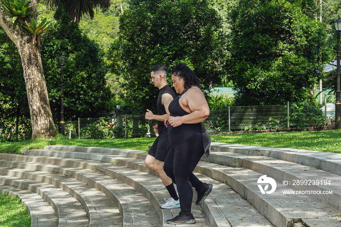 Two friends going on a run together in the park