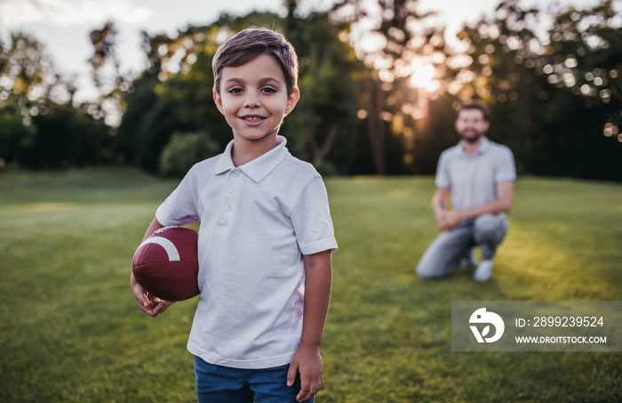 Dad with son playing American football