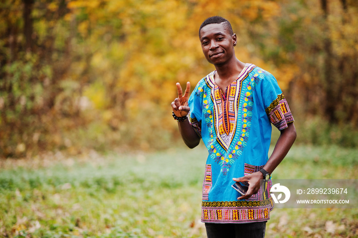 African man in africa traditional shirt on autumn park.