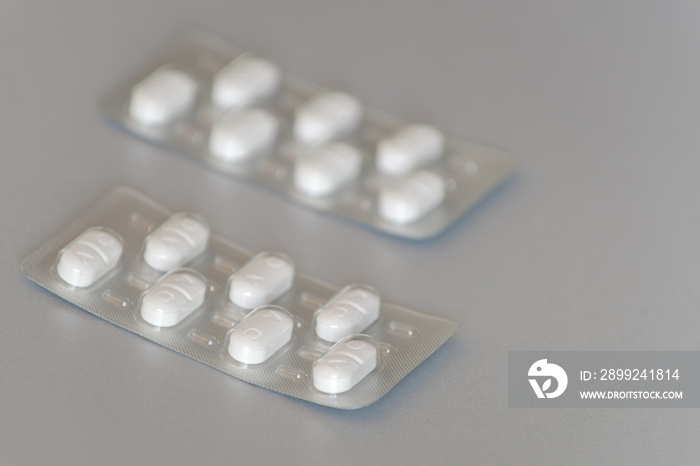 Antibiotics (prescription drug) lying on a gray background.