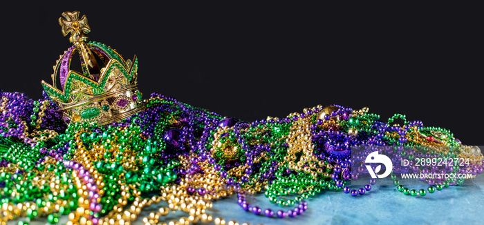 New Orleans mardi gras crown and beads in green, gold, and purple