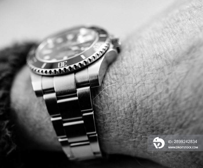 Iconic, swiss-made men’s automatic divers watch seen on a man’s wrist.