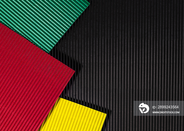 February Black History Month. Abstract corrugated paper geometric black, red, yellow, green background. Copy space, place for your text.