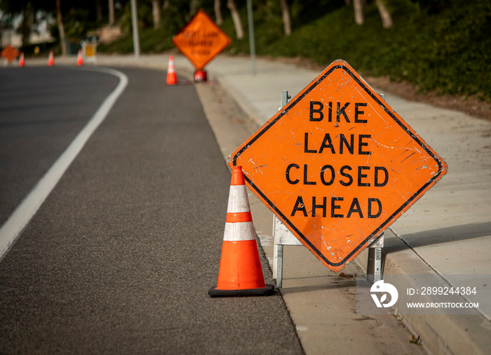 Bike Lane Closed Ahead with other sign in distance