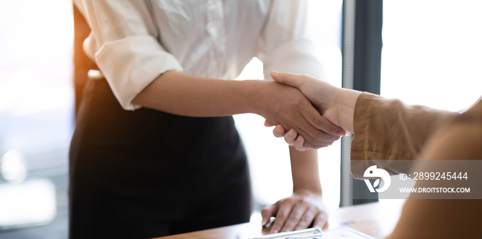 Real estate agents and customers shake hands to congratulate on signing a contract to buy a house with land and insurance, handshake and Good response concept.