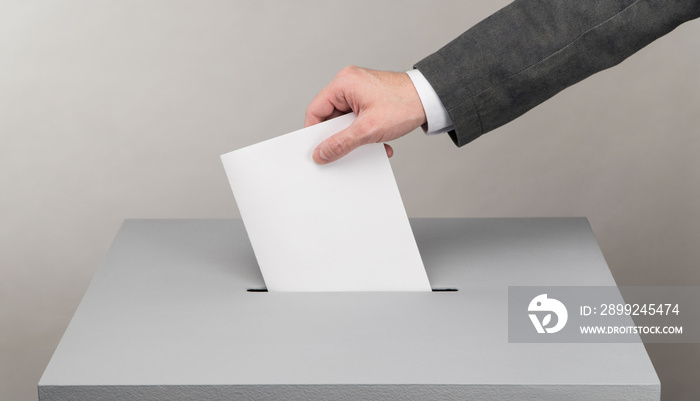 Gray ballot box. Presidential and parliamentary elections. The voter throws the ballot into the ballot box.