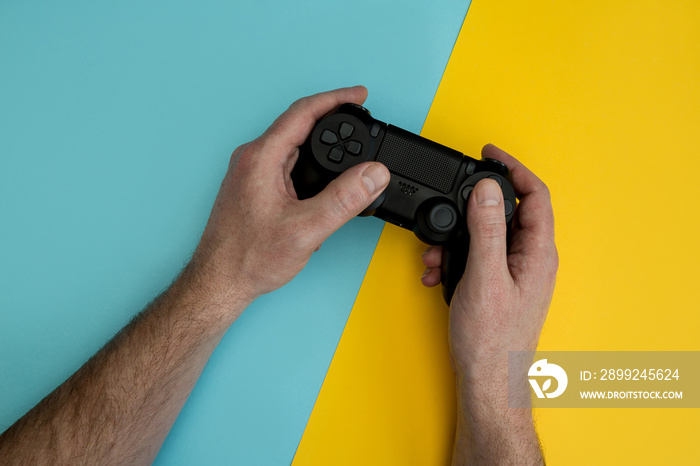 Man playing video game holding gaming controller in hands