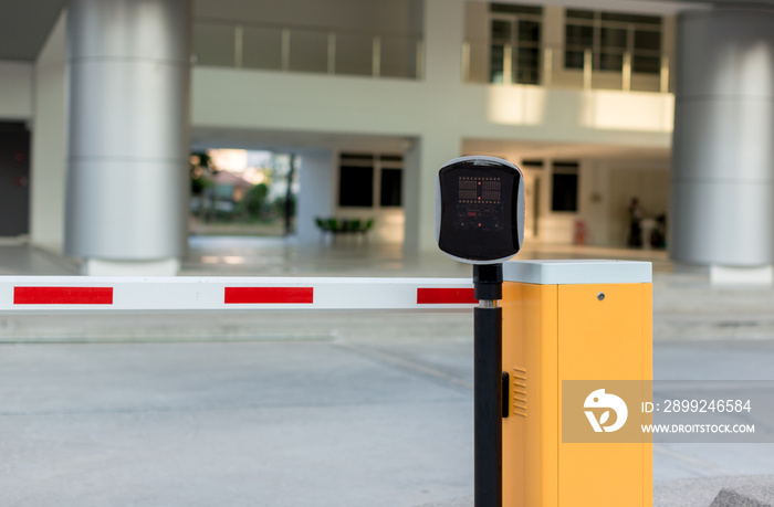 car park automatic entry system. Security system for building access - barrier gate stop with toll booth, traffic cones.