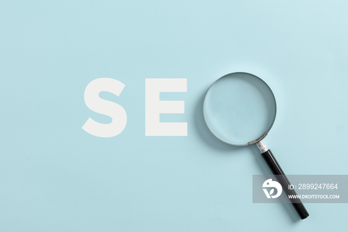 Magnifying glass with the word SEO search engine optimization.