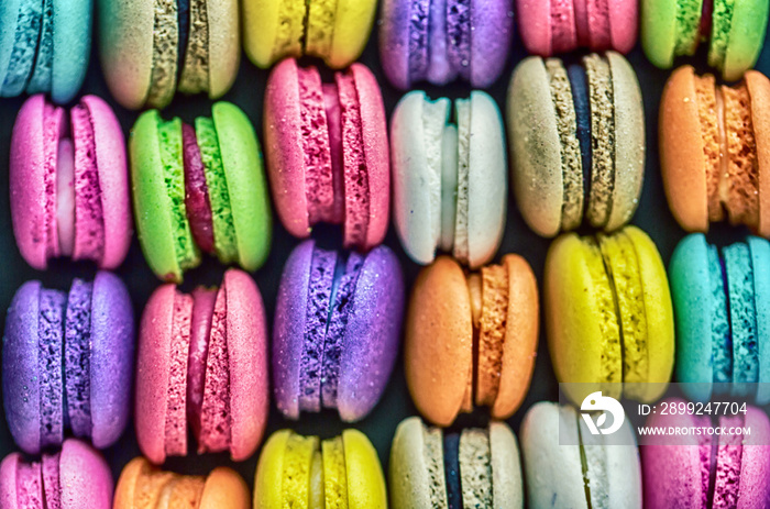 Top view colorful macarons dessert with vintage pastel tones. Colorful french macarons background,Different colorful macaroons background.Tasty sweet color macaron,Bakery concept.Selective focus.