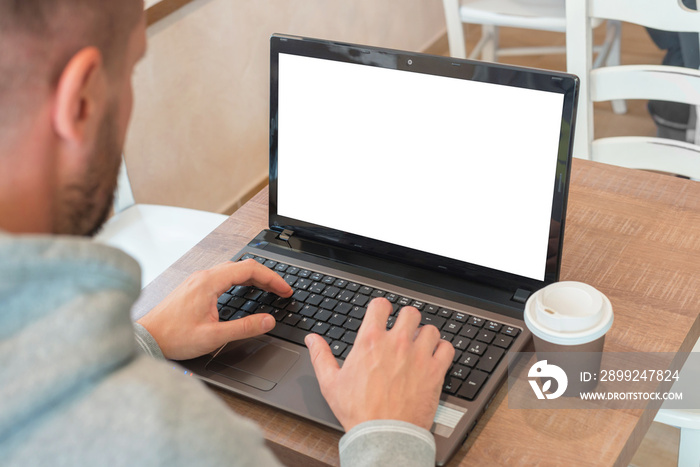 Man work on laptop computer with isolated blank screen for web site presentation mockup.