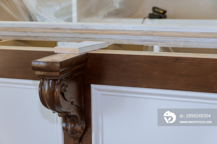 Installation of corbels on the island in new kitchen for granite countertops.