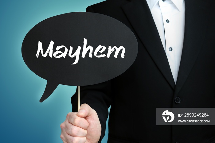 Mayhem. Lawyer in suit holds speech bubble at camera. The term Mayhem is in the sign. Symbol for law, justice, judgement