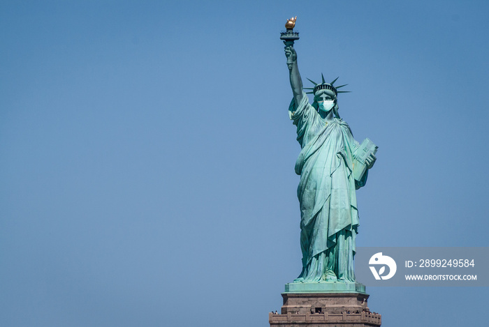 Statue of liberty wearing a surgical mask. Concept of Coronavirus, COVID-19, isolation, protection and quarantine