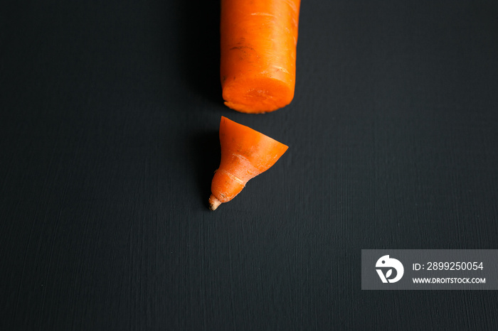 Creative work on male circumcision. Clean pruned carrots and dirty carrots lying on the table. Carrot symbolizes male penis.