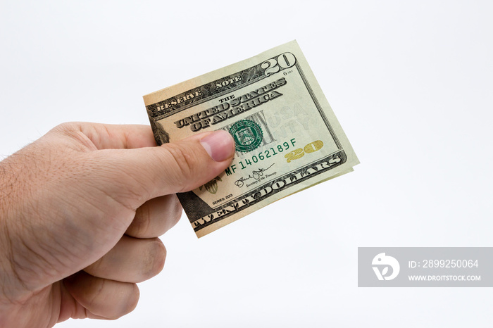 a close up photo of a Caucasian male hand holding a 20 dollar USA note