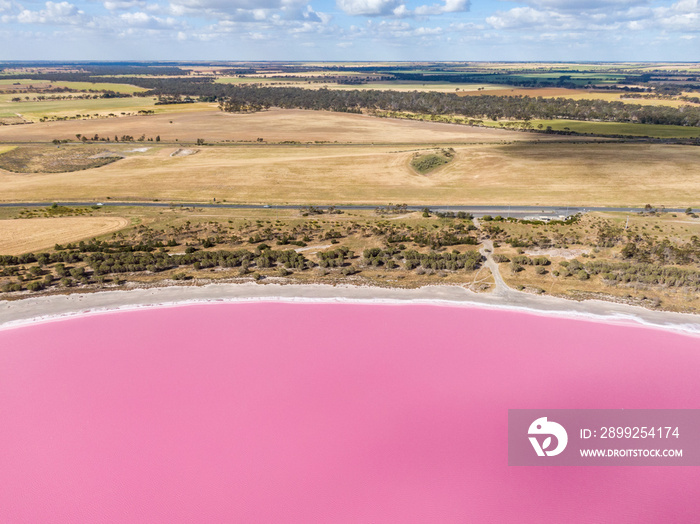 Aerial high angle drone view of Loch Iel, also called Pink Lake, near the village of Dimboola in Victoria, Australia. The pink color results from red pigment secreted by microalgae in summer.