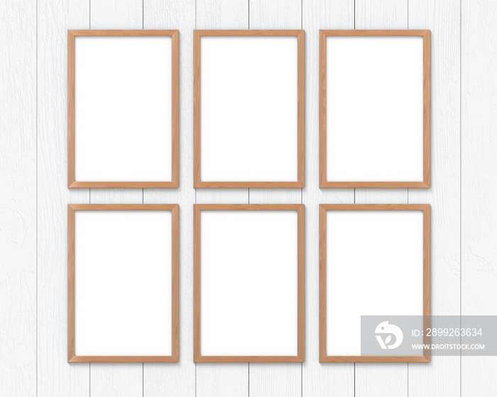 Set of 6 vertical wooden frames mockup with a border hanging on the wall. Empty base for picture or text. 3D rendering.