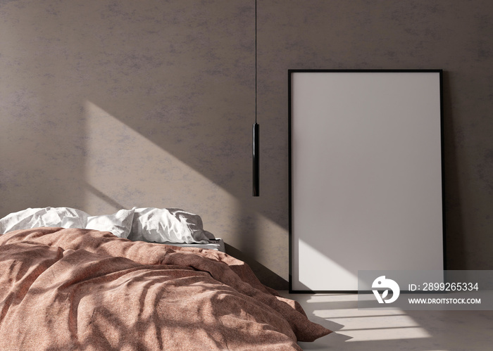 Empty vertical picture frame standing on concrete floor in modern bedroom. Mock up interior in minimalist, contemporary style. Free space for picture or poster. Bed, hanging lamp. 3D rendering.