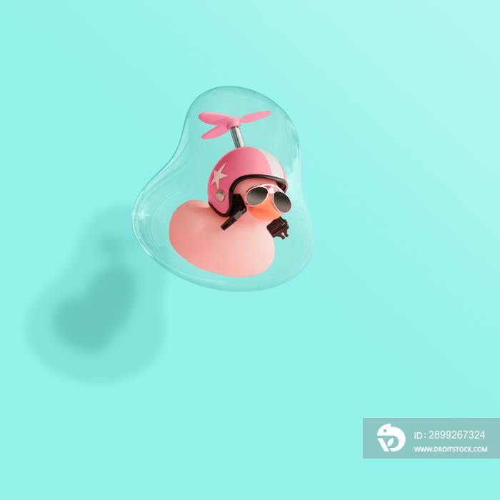 Creative composition made of pink cute little rubber duckling with a helmet and sunglasses floating in a soap bubble. Contemporary style.Creative art minimal aesthetic, minimal abstract concept