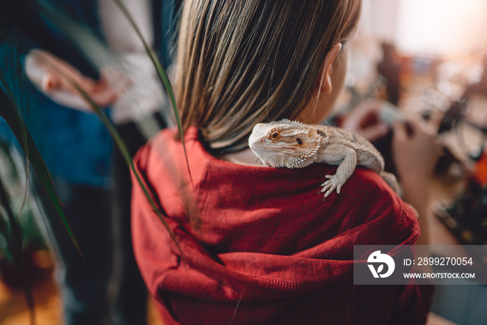 Lizard on girls shoulder