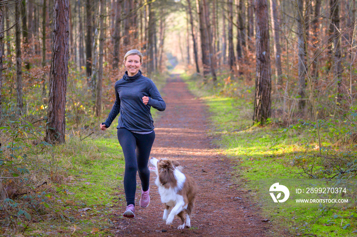 Athletic woman enjoying a morning run with a dog