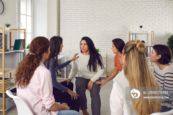 Women sharing their true stories in therapy session or support group meeting. Young friends talking, sharing news, discussing life situations, giving each other advice and helping cope with problems