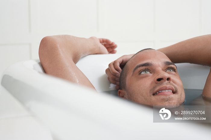 Closeup of a man relaxing in a bathtub at home