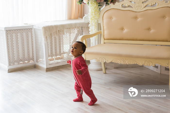 Portrait of a little african american baby boy playing indoor