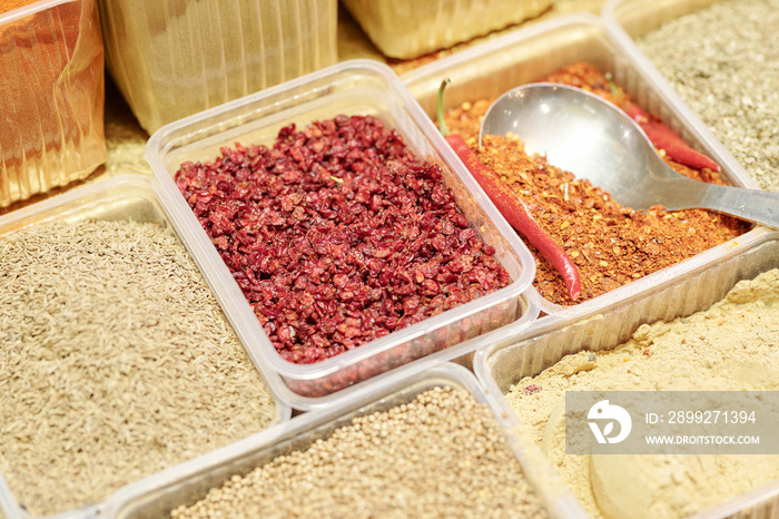 Close-up of various spices in disposable containers used for cooking savory dishes at food market