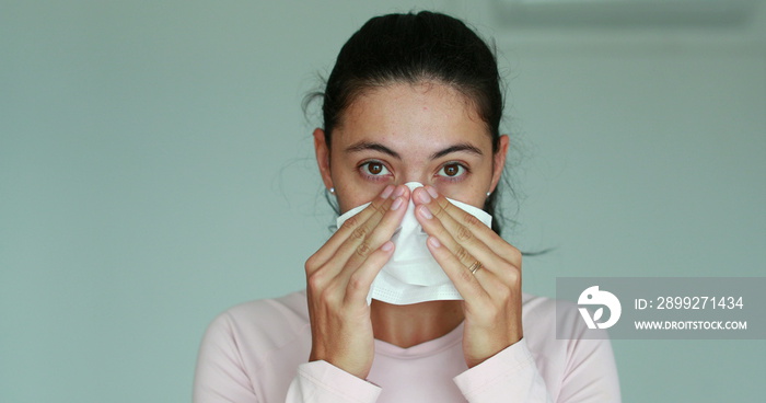 Woman putting face mask to protect from virus. Woman using face mask prevention for Corona virus outbreak. Girl covering face with surgical mask