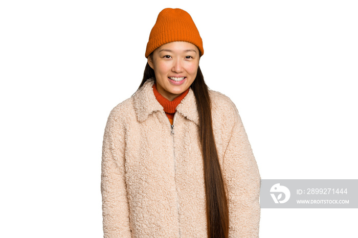 Young asian woman wearing winter clothes isolated on green chroma background happy, smiling and cheerful.