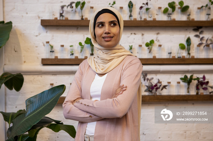 Portrait of woman wearing headscarf in flower shop